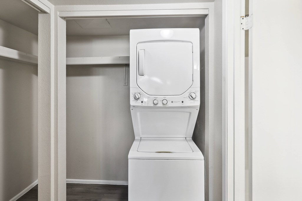 an empty laundry room with a washer and dryer